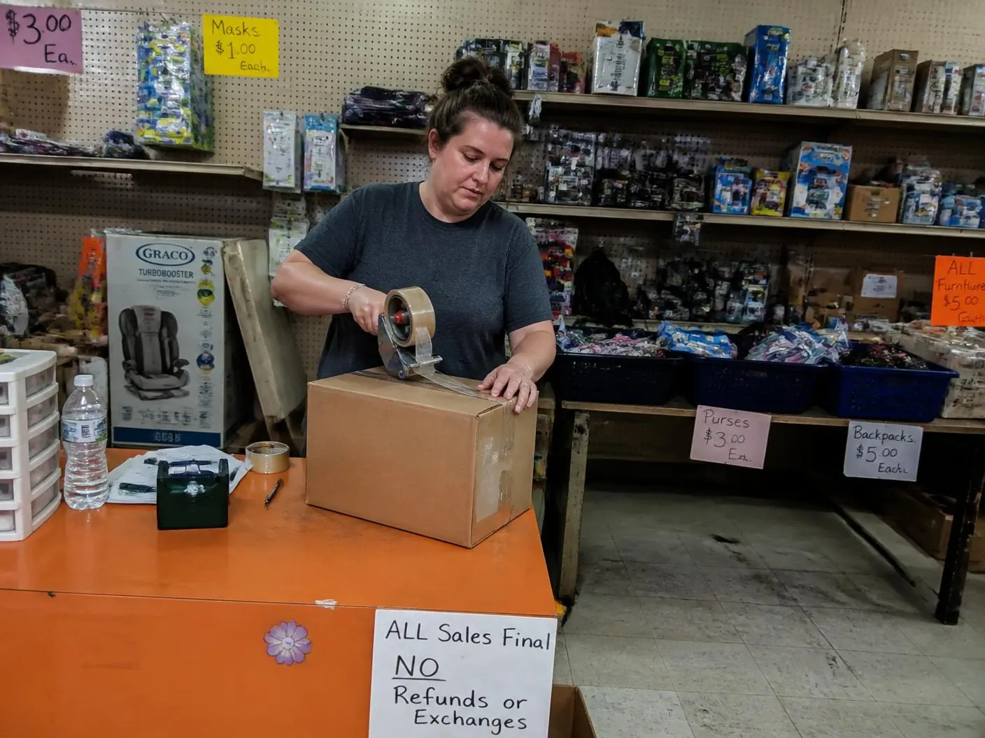 Reseller standing in their discount store stocked from liquidation pallets